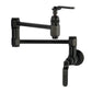Kingston Brass KS5103KL Whitaker Wall Mount Pot Filler Faucet, Antique Brass in matte black finish.