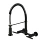 Kingston Brass GS8187CML Manhattan Double-Handle Wall-Mount Pre-Rinse Bridge Kitchen Faucet, Brushed Brass in Matte Black finish.
