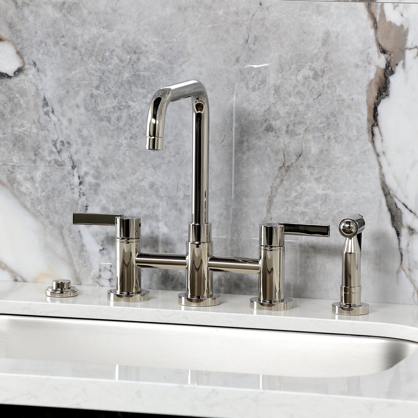 Kingston KS8287CTLBS Continental Bridge Kitchen Faucet with Brass Sprayer, Brushed Brass on a marble countertop.