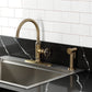 Kingston Brass KSD2433RNX Ostro Single-Handle Kitchen Faucet, Antique Brass with side spray in stylish kitchen setting.