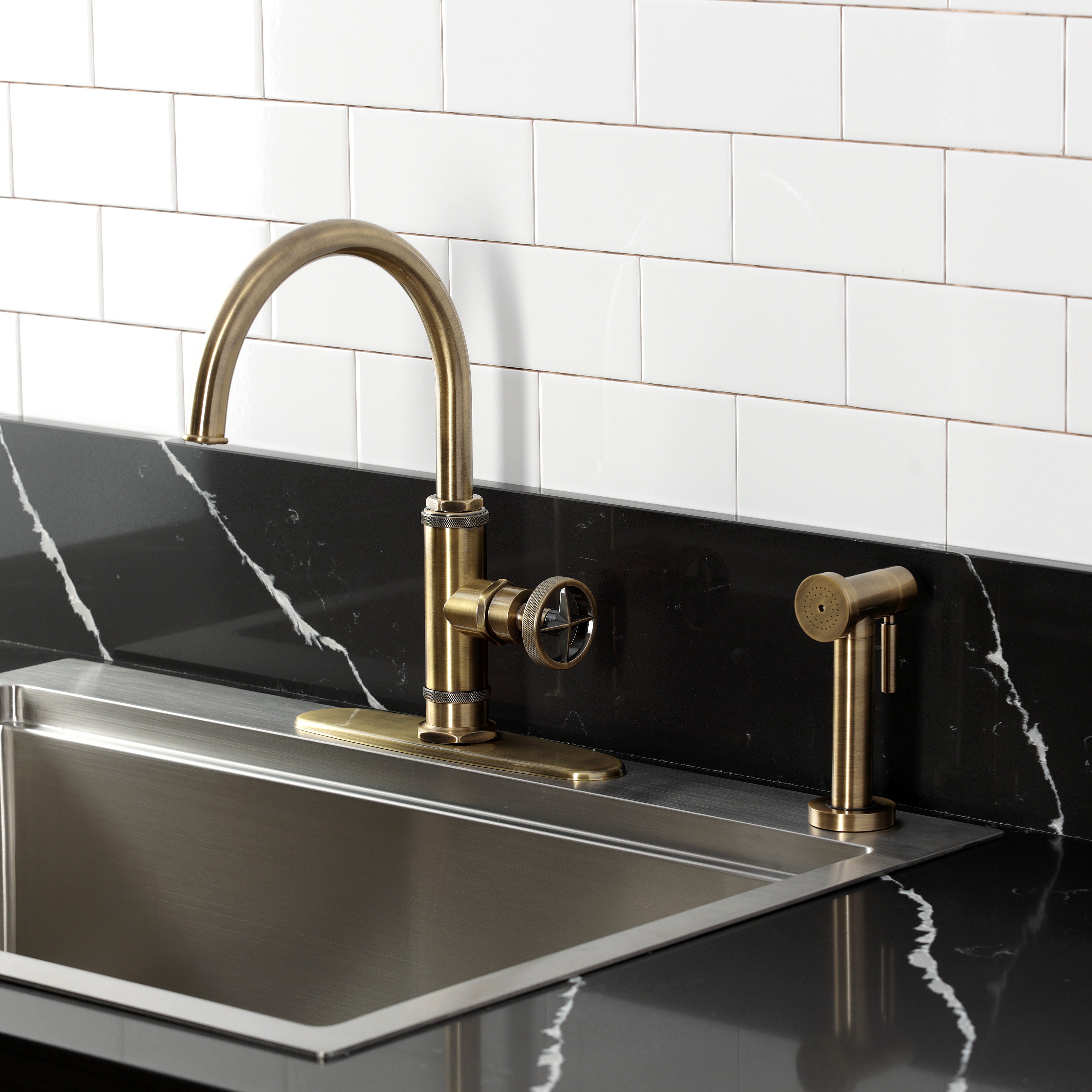 Kingston Brass KSD2433RNX Ostro Single-Handle Kitchen Faucet, Antique Brass with side spray in stylish kitchen setting.