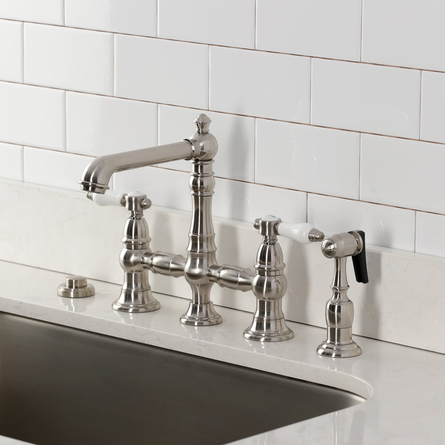 Kingston KS7277BPLBS Bel-Air Bridge Kitchen Faucet with Brass Sprayer, Brushed Brass installed on a kitchen sink.