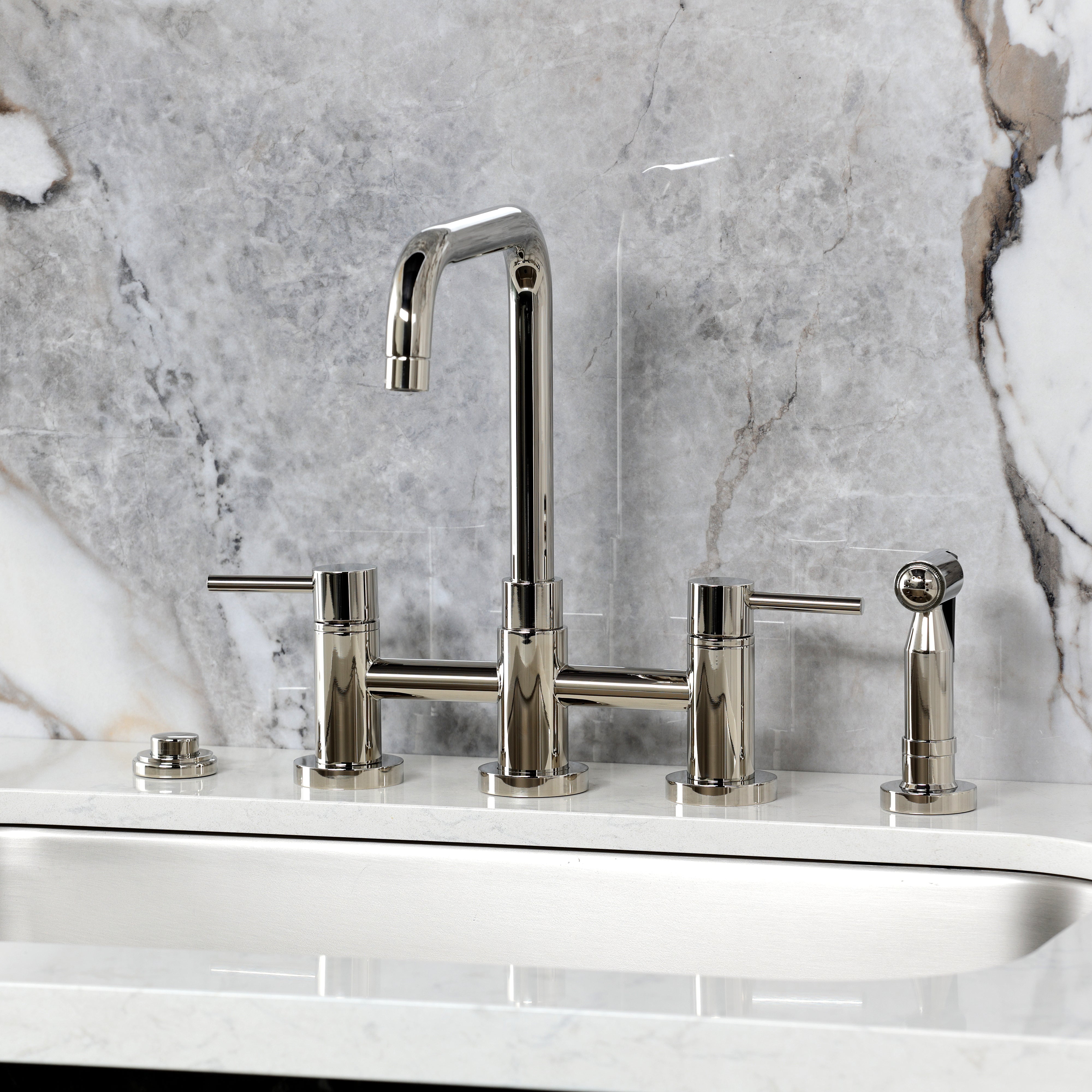 Kingston KS8287DLBS Concord Bridge Kitchen Faucet with Brass Sprayer, Brushed Brass image against marble backdrop