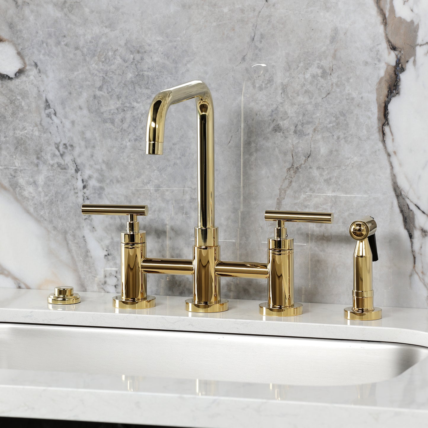Kingston KS8287CMLBS Manhattan Bridge Kitchen Faucet with Brass Sprayer, Brushed Brass on marble countertop.