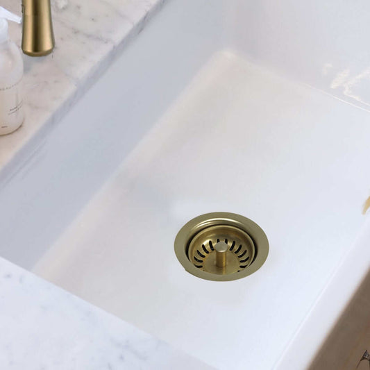 Nantucket Sink 3.5" Extended Flange Disposal Kitchen Drain in Brass - 3.5EDF-PB installed in a fireclay sink.