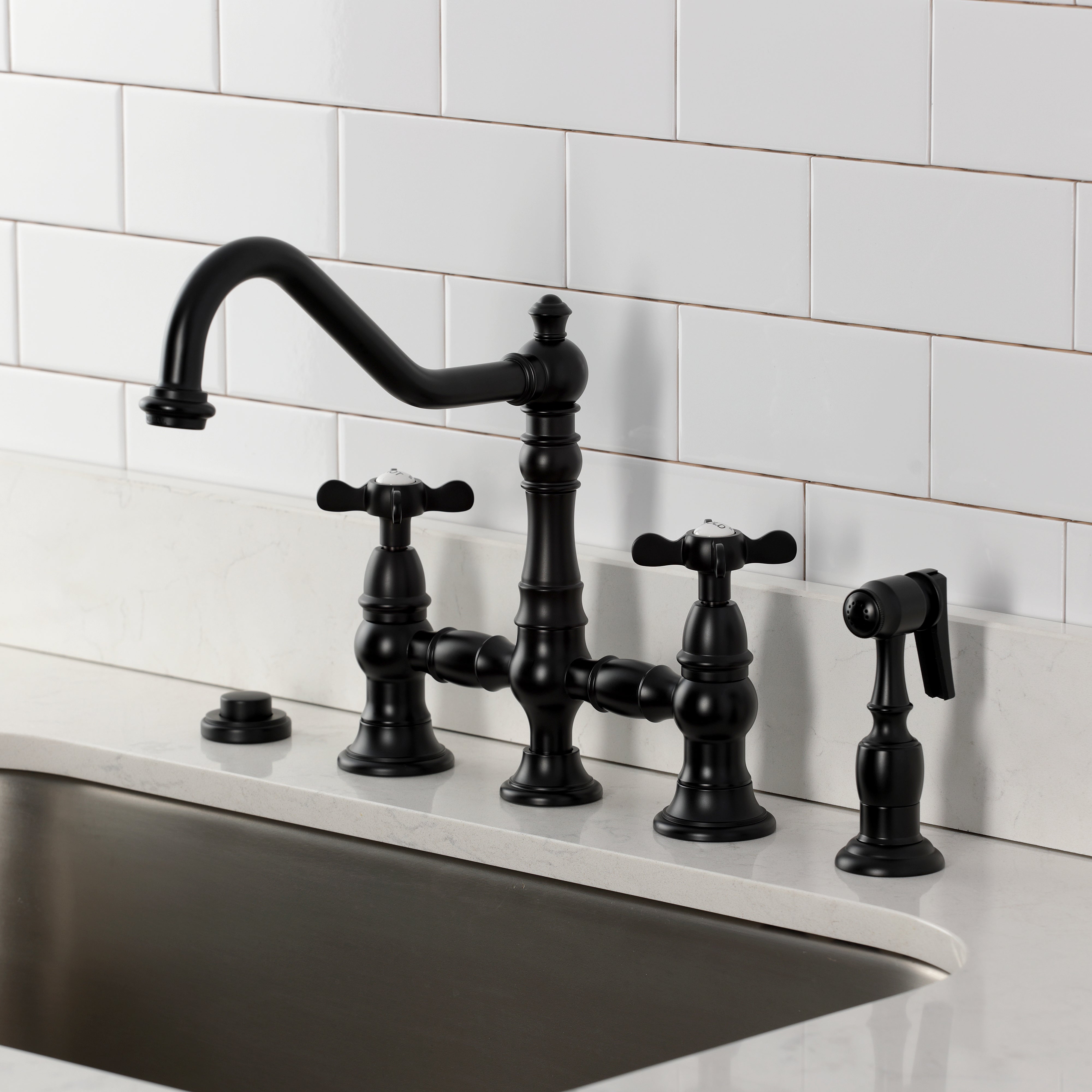 Kingston KS3277BEXBS Essex Bridge Kitchen Faucet with Brass Sprayer, Brushed Brass in a modern kitchen setting.