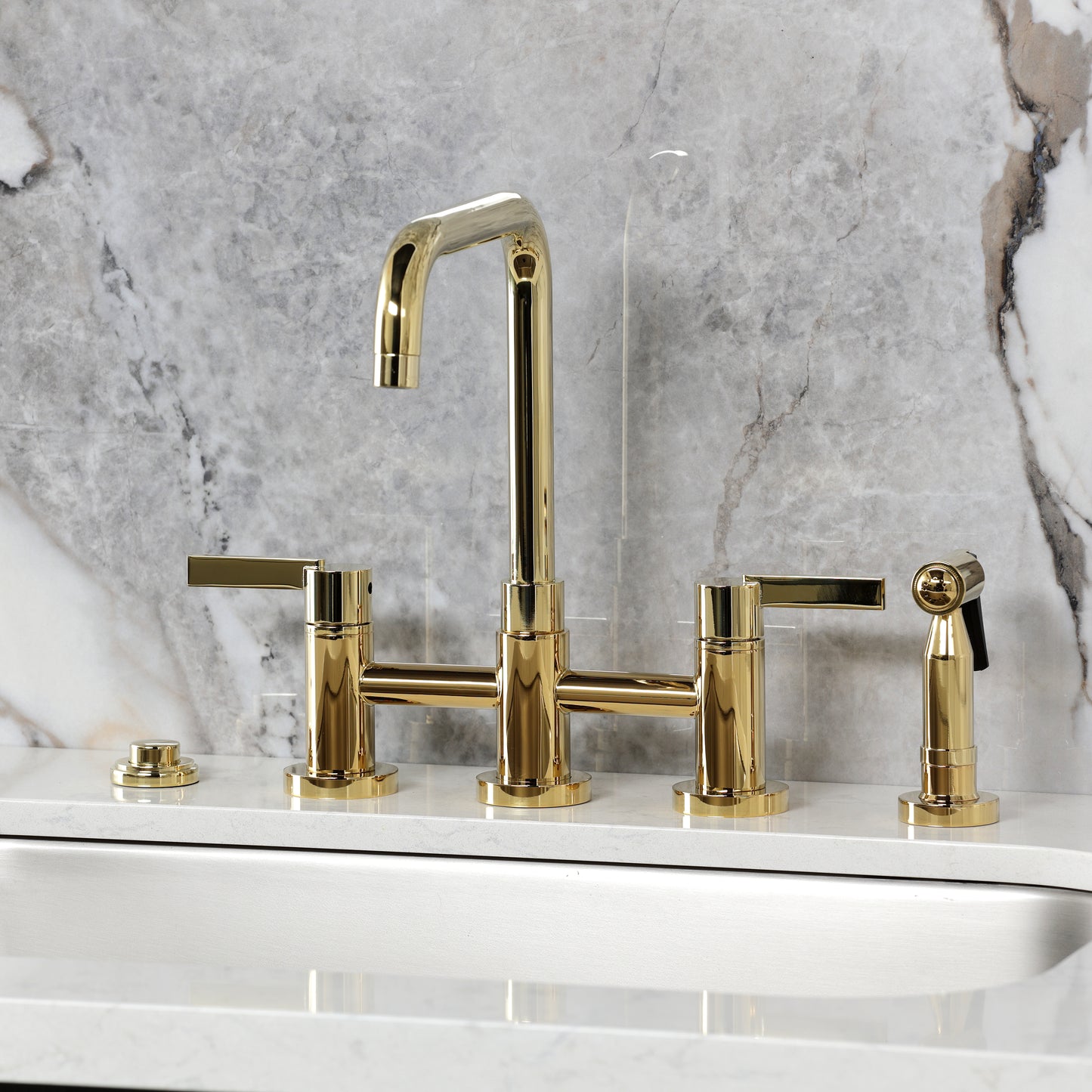 Kingston KS8287CTLBS Continental Bridge Kitchen Faucet with Brass Sprayer, Brushed Brass on marble background.