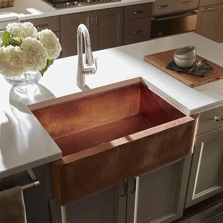Thompson Kahlo 33" Handcrafted Copper Farmhouse Kitchen Sink - 2KS-RG showcased in a stylish kitchen with fresh flowers.