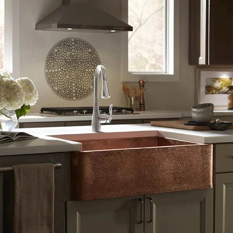 Thompson Kahlo 33" Handcrafted Copper Farmhouse Kitchen Sink - 2KS-RG showcased in a modern kitchen with floral decor.