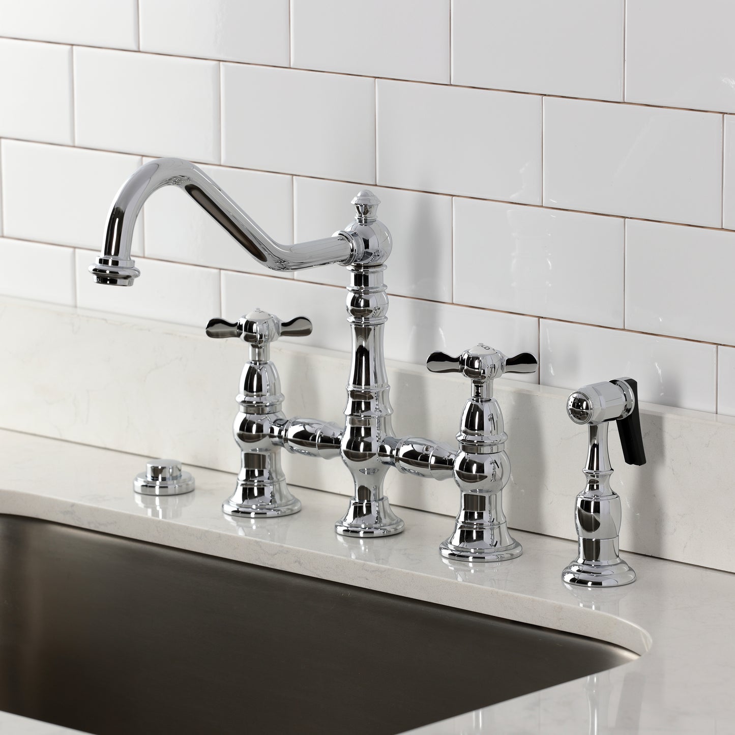 Kingston KS3277BEXBS Essex Bridge Kitchen Faucet with Brass Sprayer, Brushed Brass installed in a kitchen.
