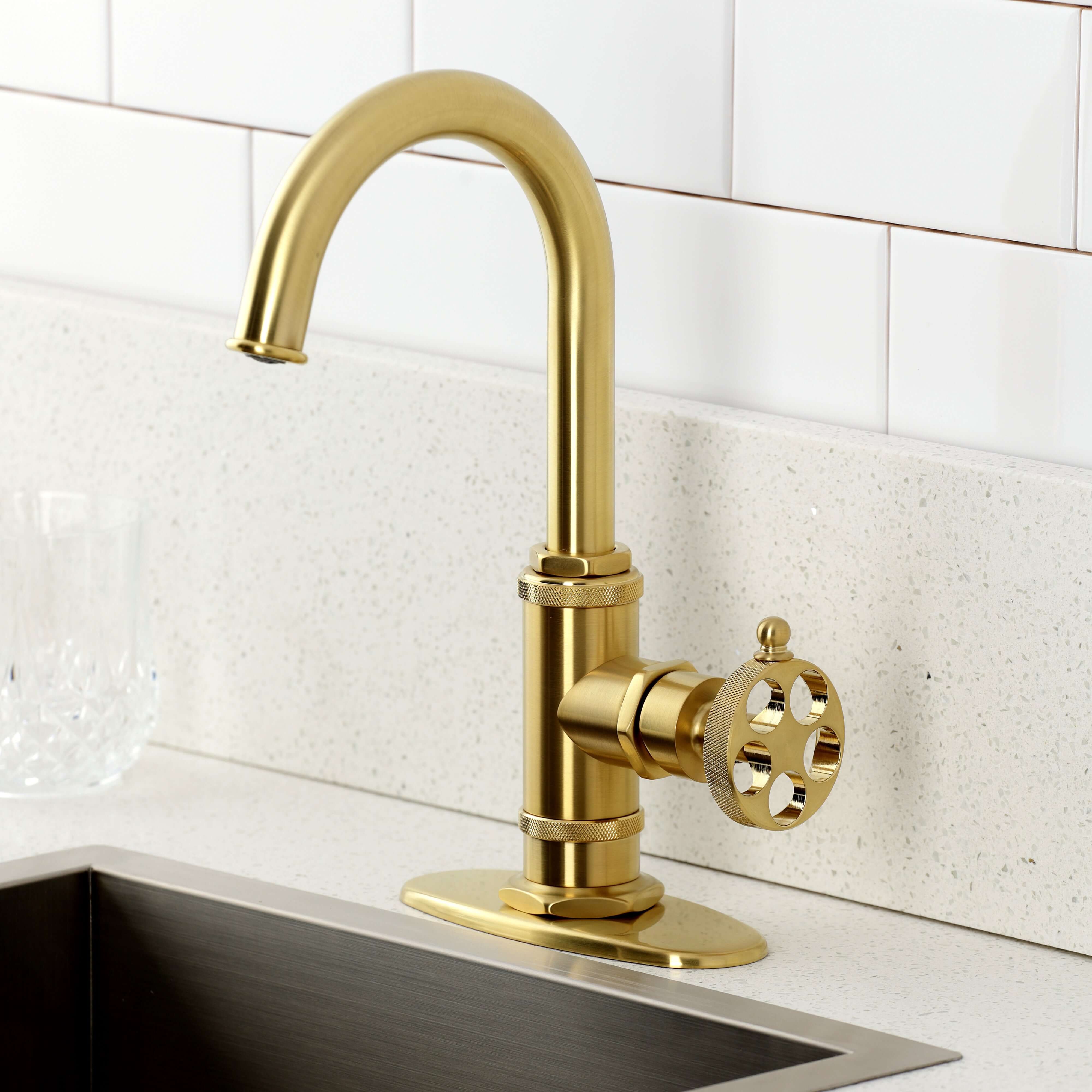 Kingston Brass KSD8503RKZ Wendell Single-Handle Bar Faucet with Knurled Handle, Antique Brass in a sleek kitchen.