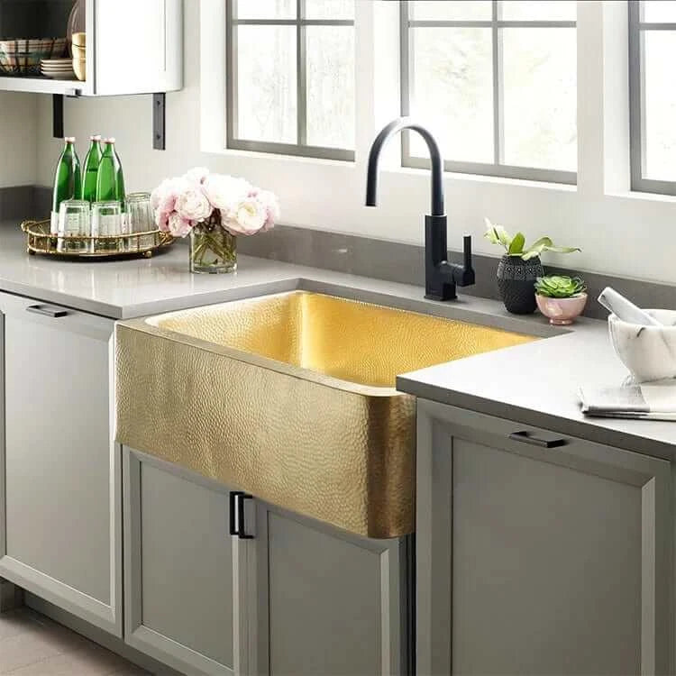 Thompson Quiroga 33" Hammered Semi-Satin Brass Farmhouse Kitchen Sink - KSA-3322HPB installed in a modern kitchen.