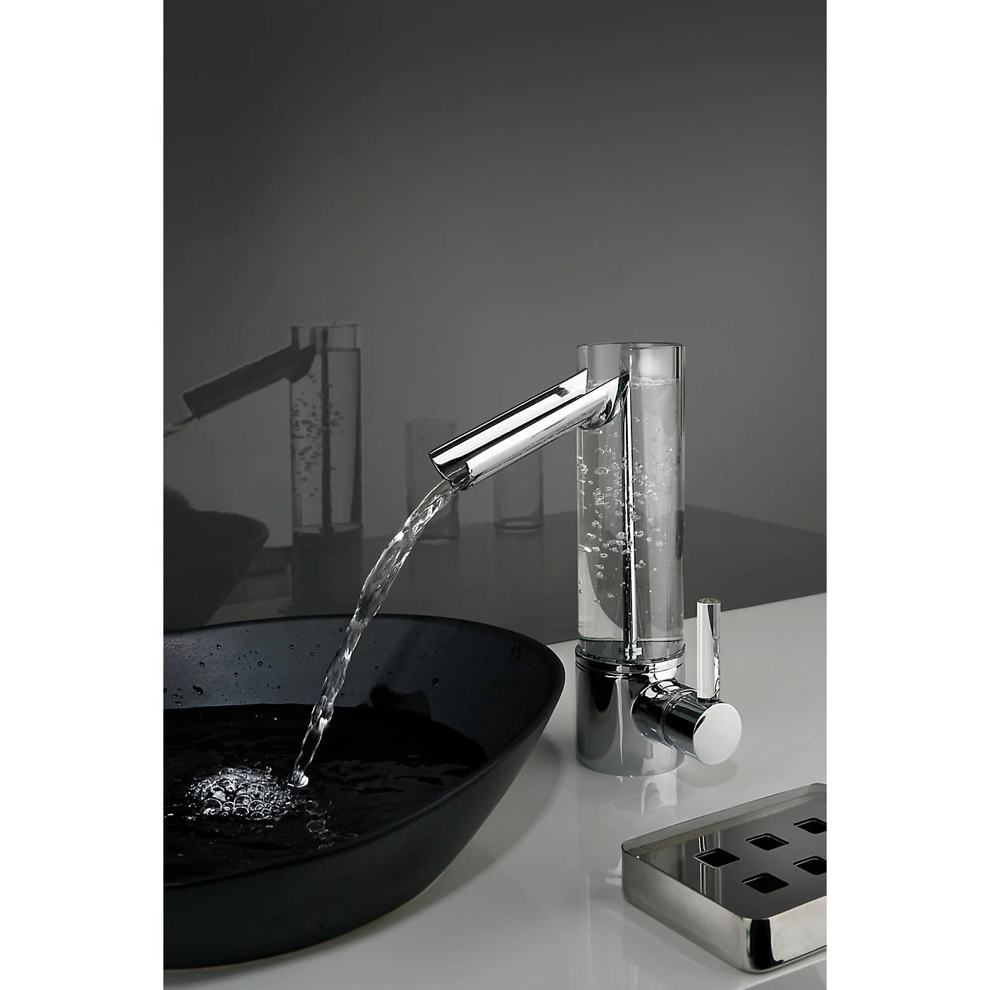 UFFIZI chrome and glass bathroom trough faucet showing water flow feature