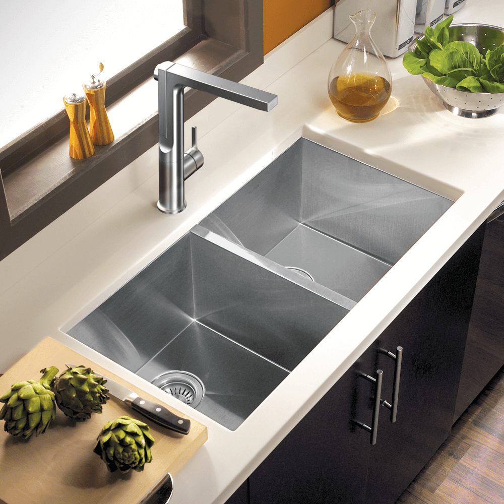 HOUZER ASCEND Matte Black Integrated Single Handle Pull-Up Kitchen Faucet with stainless steel sink and countertops.