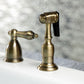 Kingston Brass "Antique Brass" widespread kitchen faucet  with spray head accessory on a blurred background