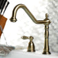 Kingston Brass "Antique Brass" widespread kitchen faucet and handles on a blurred background