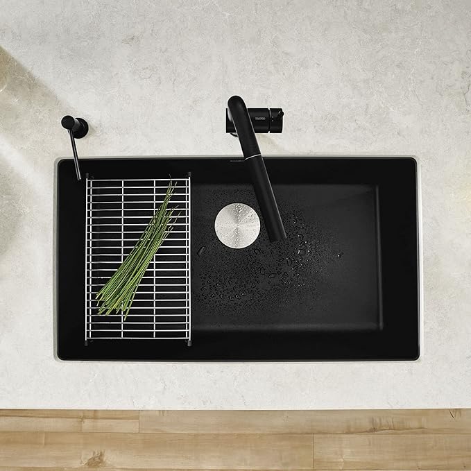 Blanco Silgranit Super Single 32"  kitchen sink in Coal Black with an optional grid and matching faucet on a light countertop