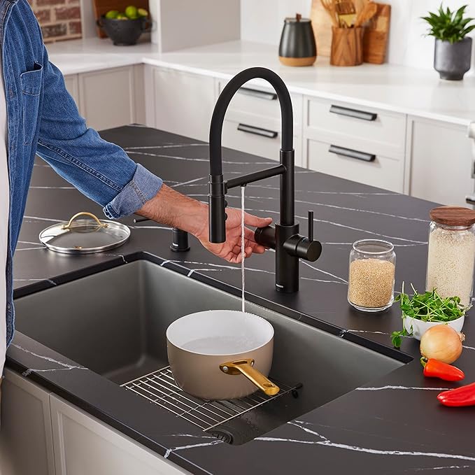 Person washing a pot in Blanco Silgranit Super Single 32"  kitchen sink in Volcano Gray 