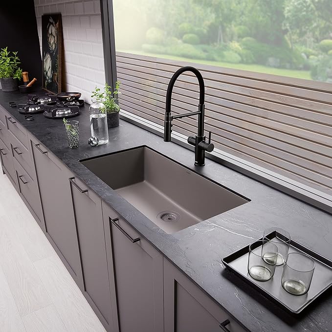 Modern kitchen with a black faucet and Blanco Silgranit Super Single 32"  kitchen sink in Volcano Gray in a gray countertop.