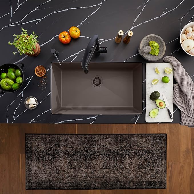 Blanco Silgranit Super Single 32"  kitchen sink in Volcano Gray with various items on a dark marble countertop