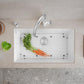White Blanco Precis 32" Silgranit kitchen sink with grid and vegetables on a neutral countertop