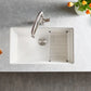 Modern White Blanco Precis 32" Silgranit kitchen sink with faucet on a gray countertop with decorative elements.