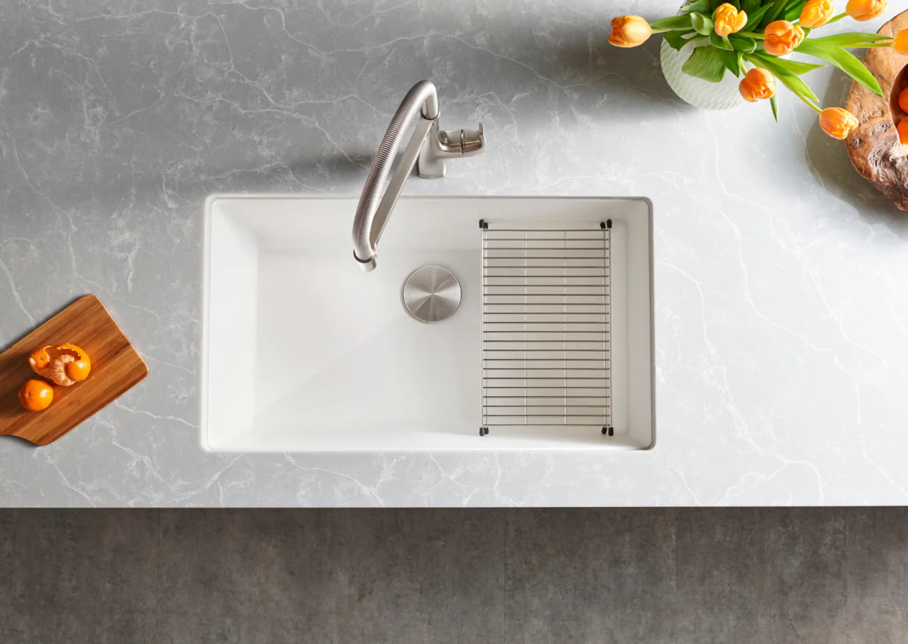 Modern White Blanco Precis 32" Silgranit kitchen sink with faucet on a gray countertop with decorative elements.