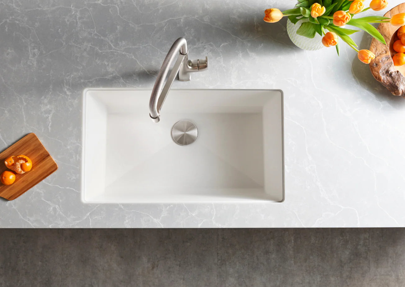 White Blanco Precis 32" Silgranit kitchen sink with silver faucet on a gray countertop