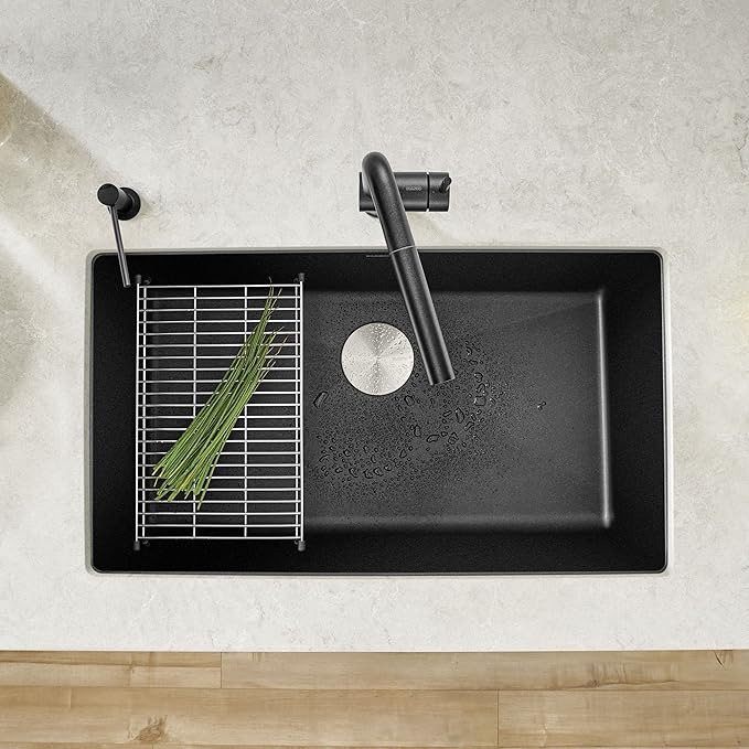 Blanco Silgranit Super Single 32"  kitchen sink in Anthracite with a grid and faucet on a light gray countertop.