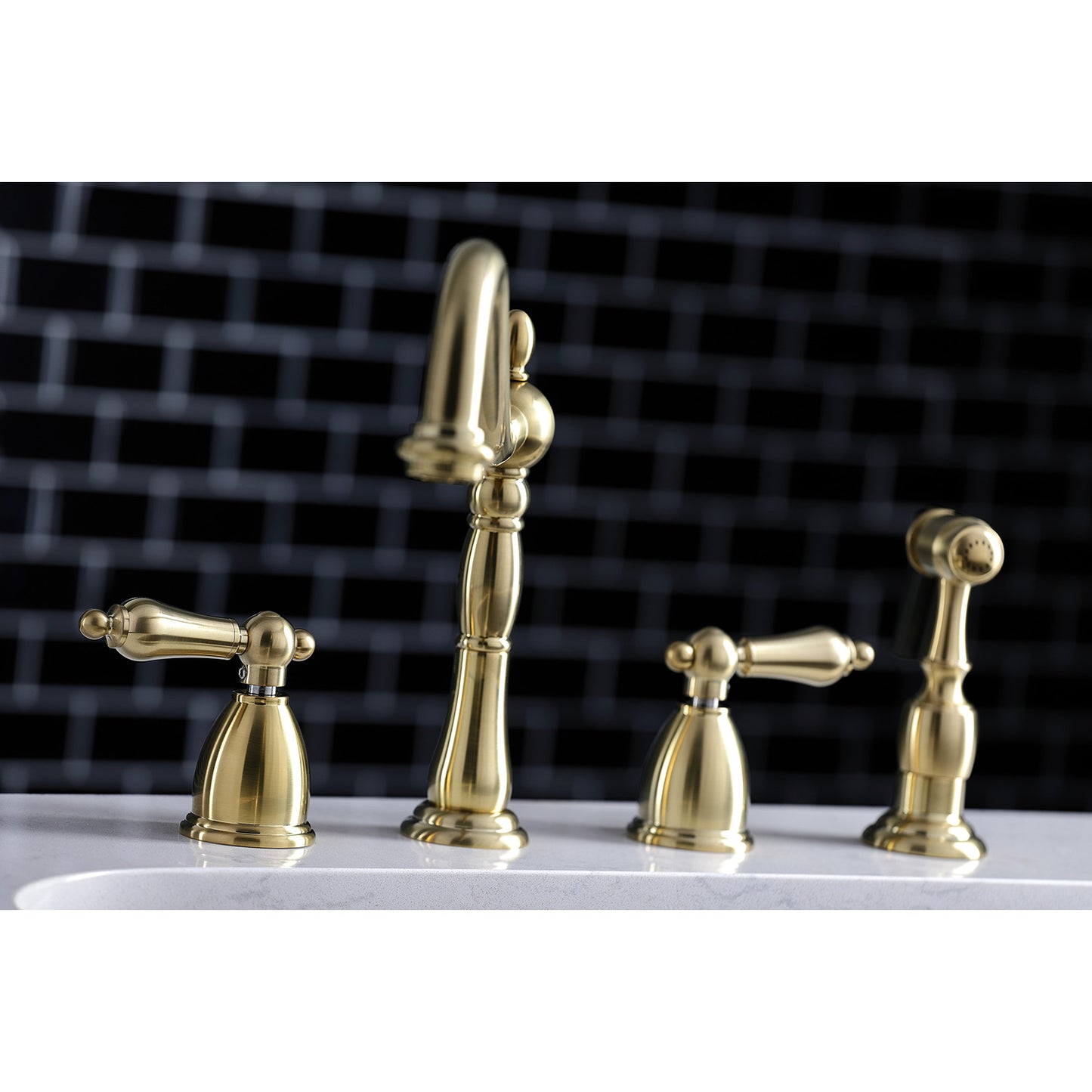 Kingston Brass "Brushed Brass" widespread kitchen faucet set on a white surface with a black tiled wall background