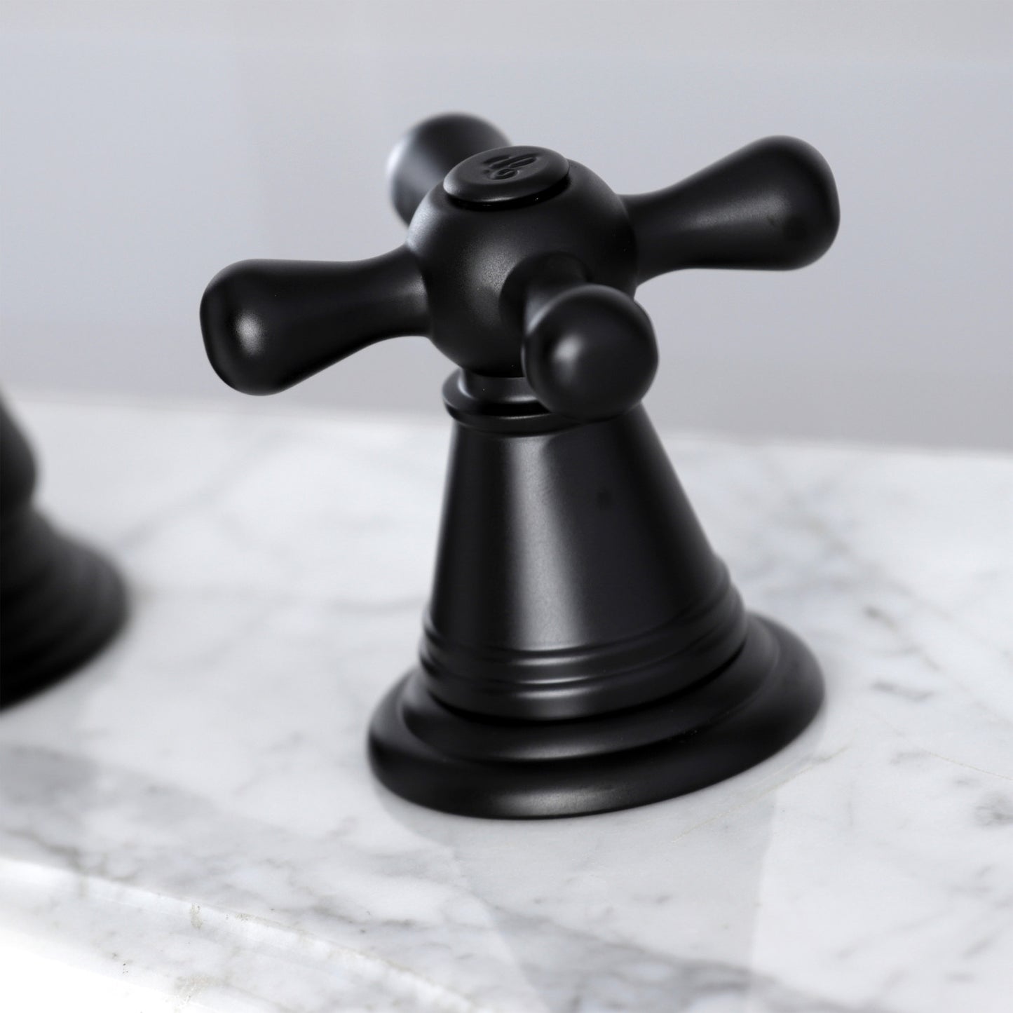 KINGSTON Brass Widespread Bathroom Faucet with Pop-Up Drain - FSC1979AAX close-up view of the stylish black lever handle on marble surface