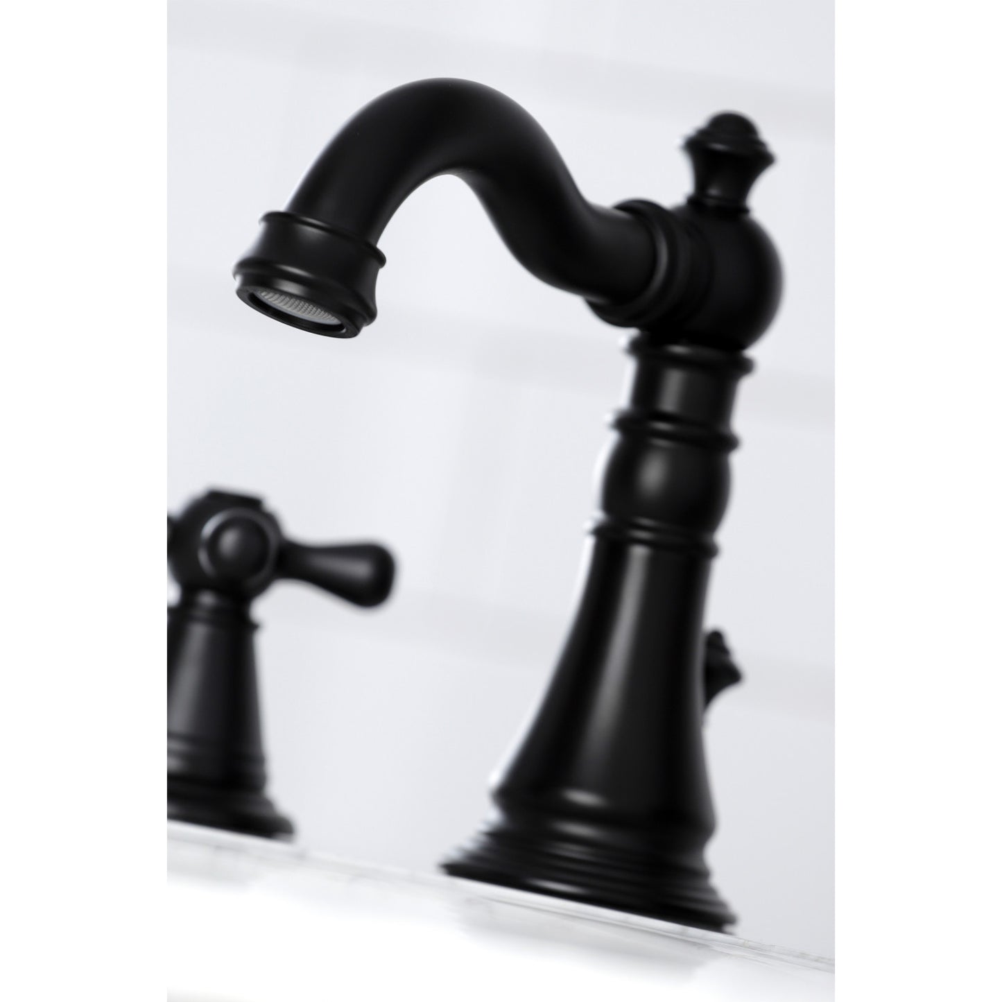 Close-up view of the spout of the KINGSTON Brass Widespread Bathroom Faucet with Pop-Up Drain - FSC1979AAX.