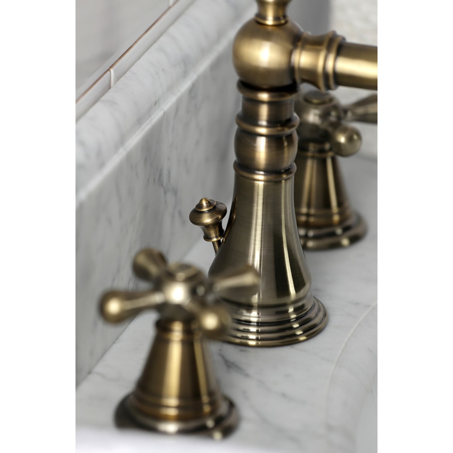Close-up of KINGSTON Brass Widespread Bathroom Faucet with Pop-Up Drain - FSC1979AAX showing detailed Victorian design.