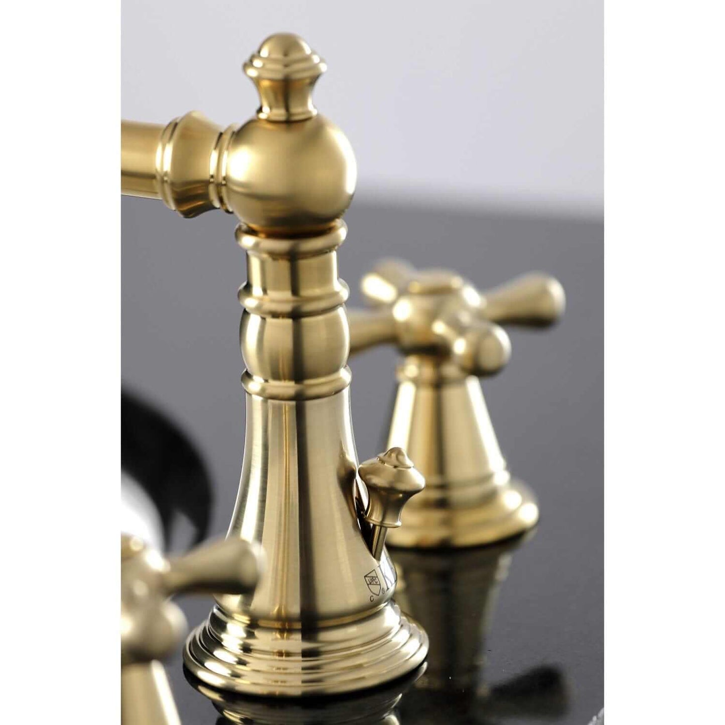 Close-up view of KINGSTON Brass Widespread Bathroom Faucet with Pop-Up Drain - FSC1979AAX showcasing Victorian design.