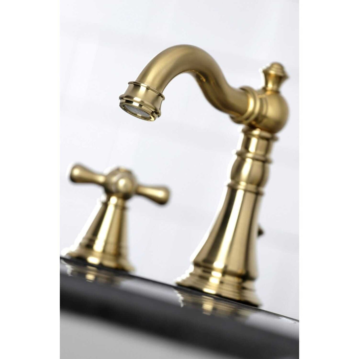 Close-up view of KINGSTON Brass Widespread Bathroom Faucet with Pop-Up Drain - FSC1979AAX showcasing elegant spout and handle.