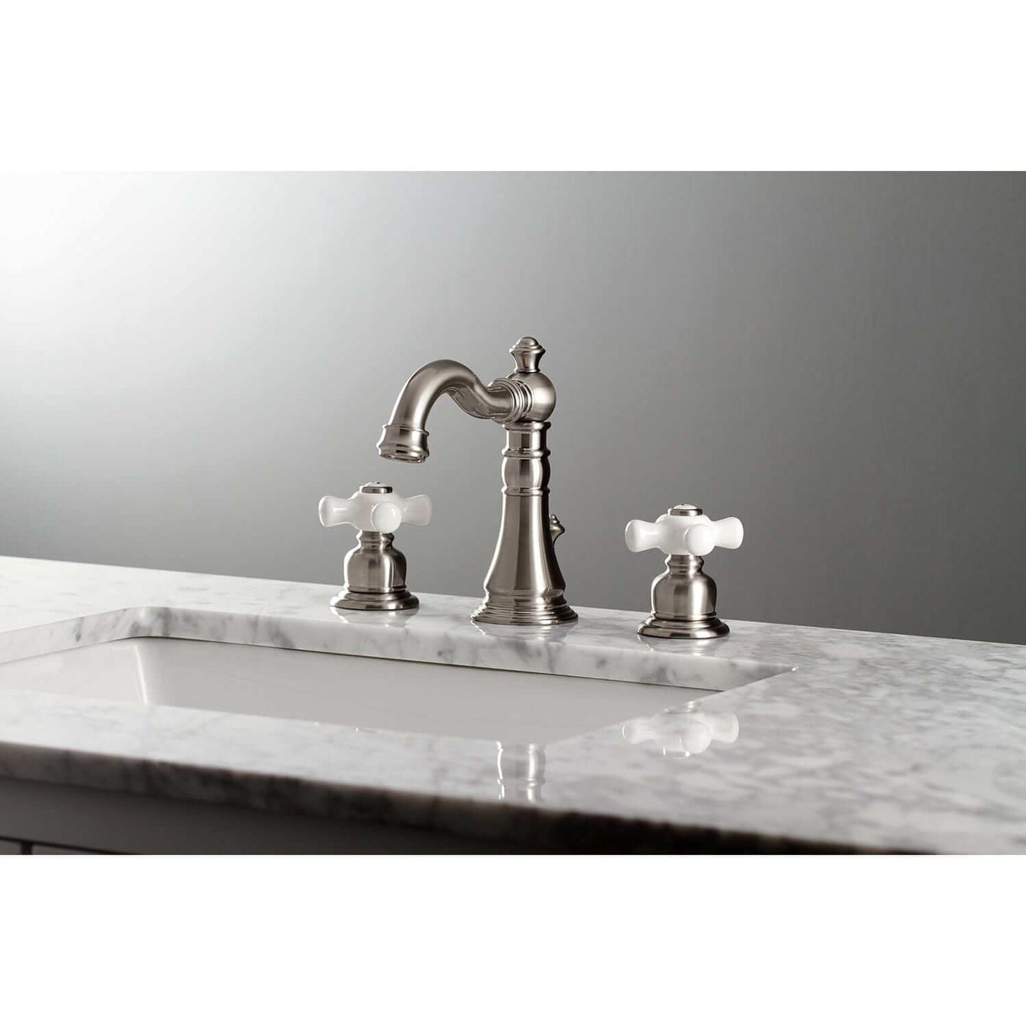 KINGSTON Brass American Classic Widespread Bathroom Faucet angled view showcasing Victorian design with white handles.
