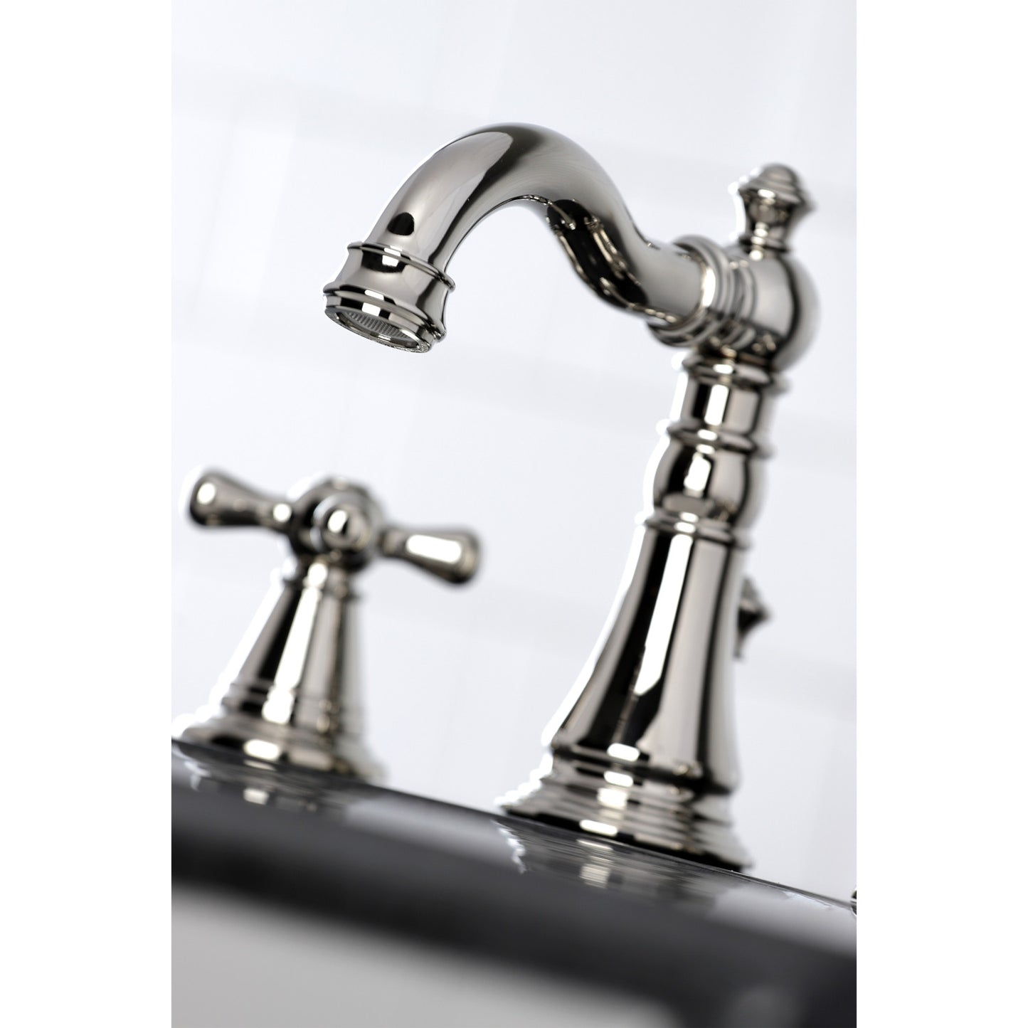 Close-up view of KINGSTON Brass Widespread Bathroom Faucet with Pop-Up Drain - FSC1979AAX showcasing elegant spout and handle design.