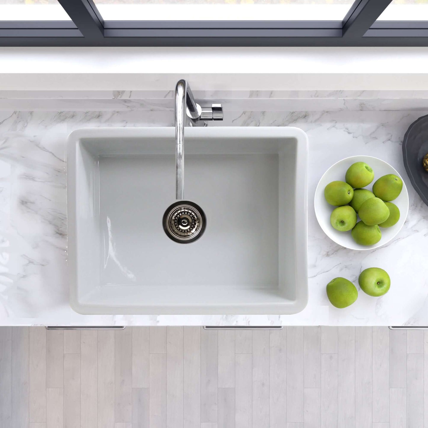 Top view of Nantucket 24" Island Collection Fireclay White Single Bowl Dualmount Sink ISFC24W-SB1 with faucet and green apples.