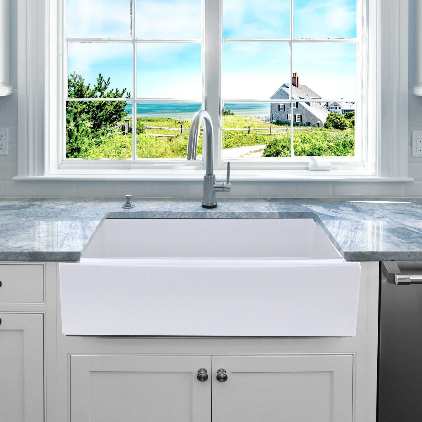 Nantucket 36" Reversible Italian Fireclay Farmhouse Sink - ISFCW36x18SO displayed in a modern kitchen with a scenic view.