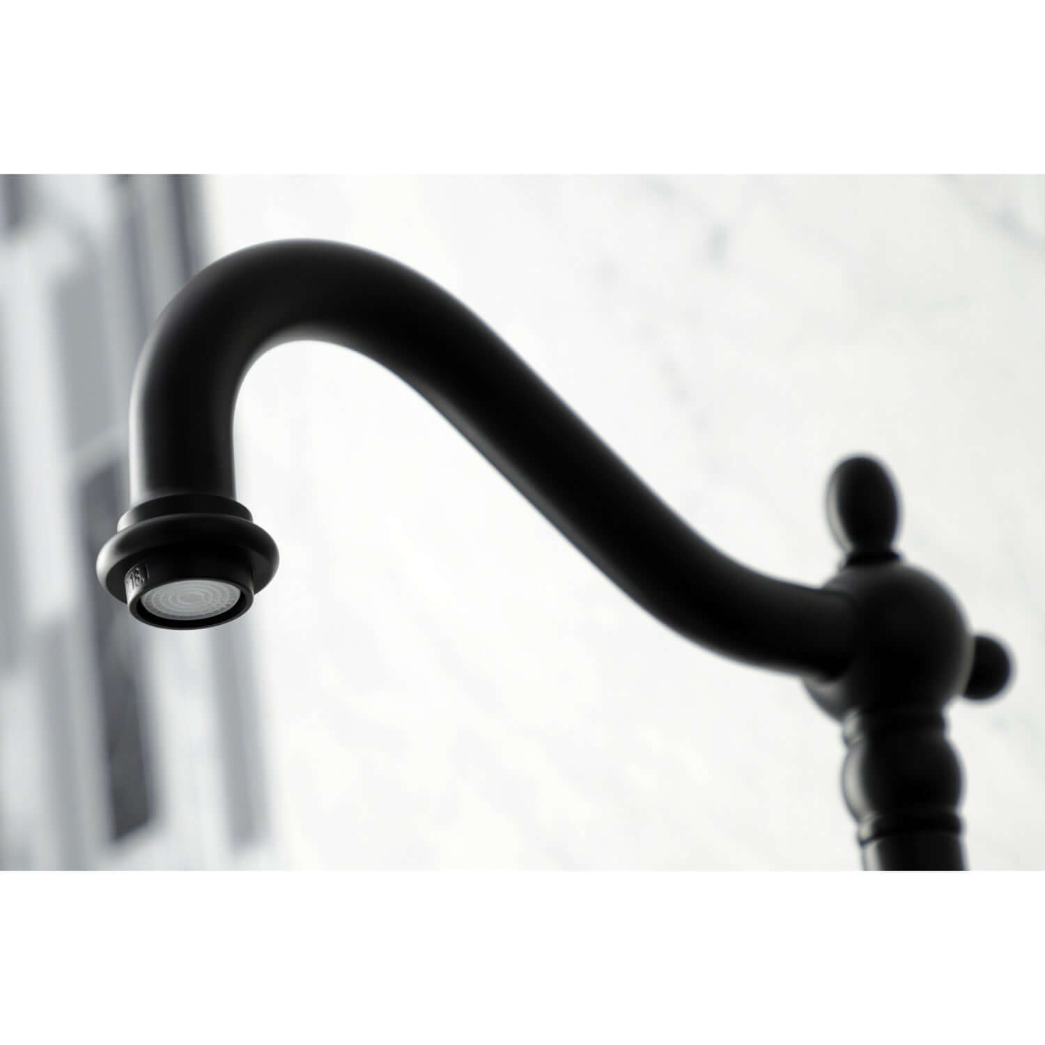 Faucet detail of Kingston Brass double-handle 2-hole wall-mount bridge kitchen faucet in matte black against a white background
