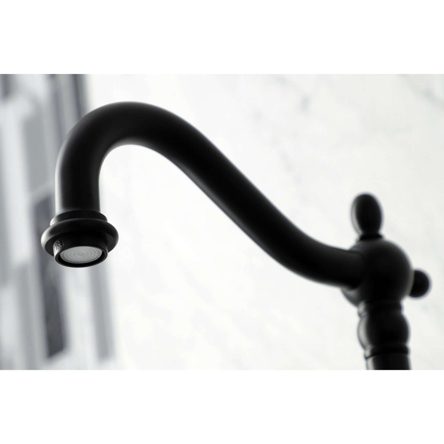 Faucet detail of Kingston Brass double-handle 2-hole wall-mount bridge kitchen faucet in matte black against a white background