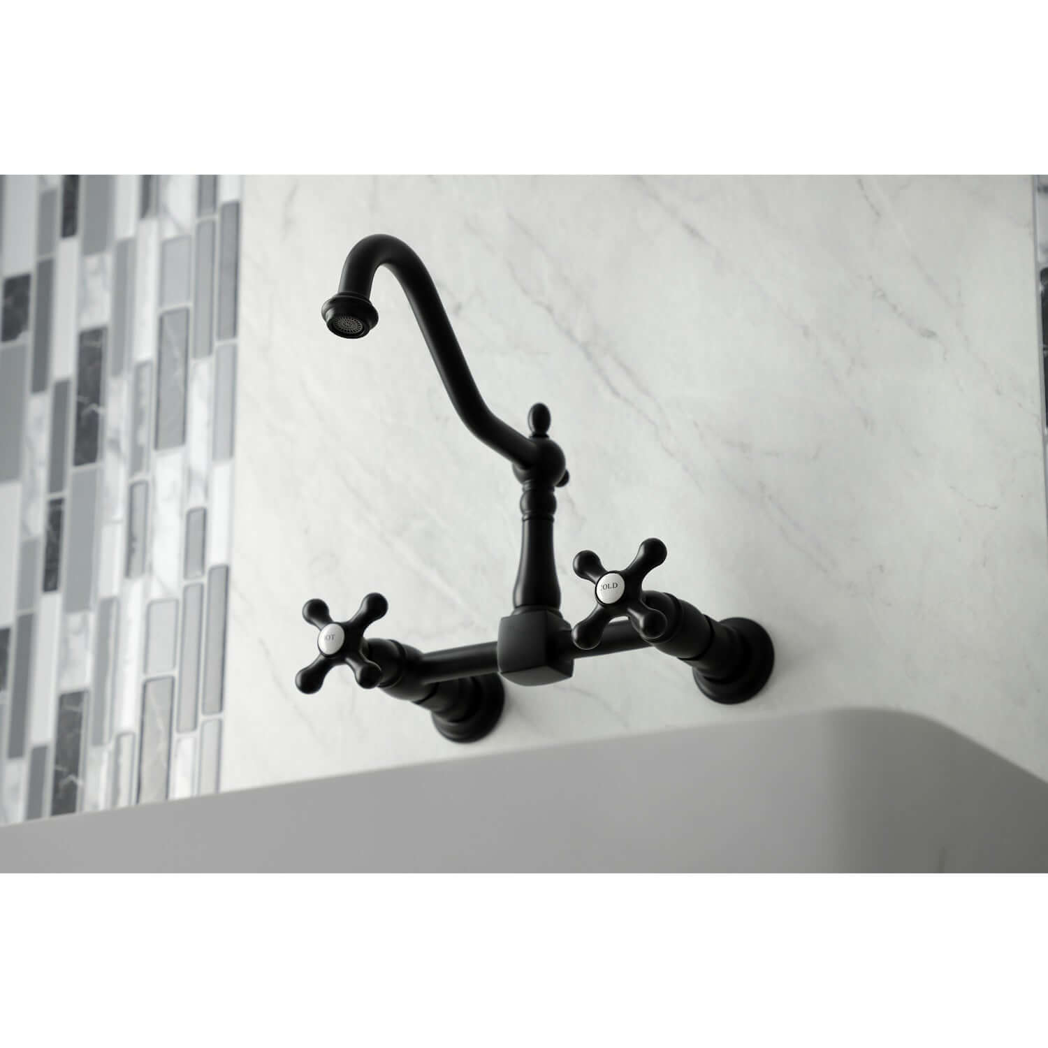 Kingston Brass matte black double-handle 2-hole wall-mount bridge kitchen faucet mounted on a white wall with a tiled backsplash
