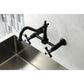 Kingston Brass matte black double-handle 2-hole wall-mount bridge kitchen faucet mounted on a tiled wall above a sink.