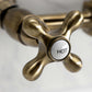 Kingston Brass antique brass double-handle 2-hole wall-mount bridge kitchen faucet faucet handle with 'HOT' label on a white background