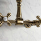 Kingston Brass antique brass double-handle 2-hole wall-mount bridge kitchen faucet on a marble background