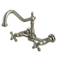 Kingston Brass polished nickel double-handle 2-hole wall-mount bridge kitchen faucet with a white background