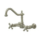 Kingston Brass brushed nickel double-handle 2-hole wall-mount bridge kitchen faucet on a white background
