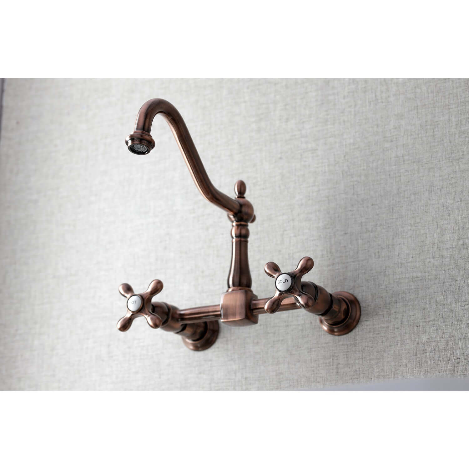 Kingston Brass antique copper double-handle 2-hole wall-mount bridge kitchen faucet wall-mounted kitchen faucet on a light gray background