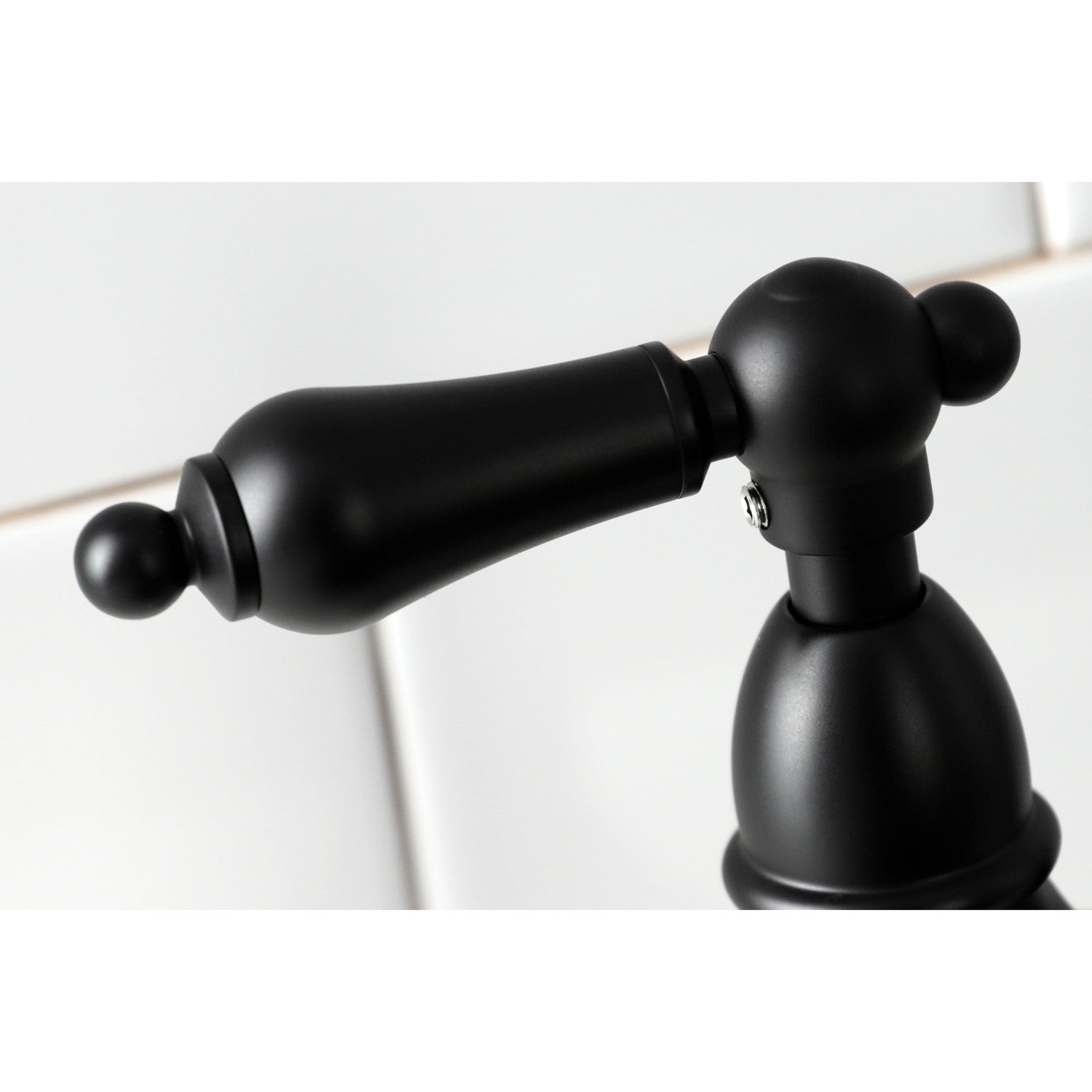Close up of Kingston Brass KS1270ALBS matte black faucet handle on a white background