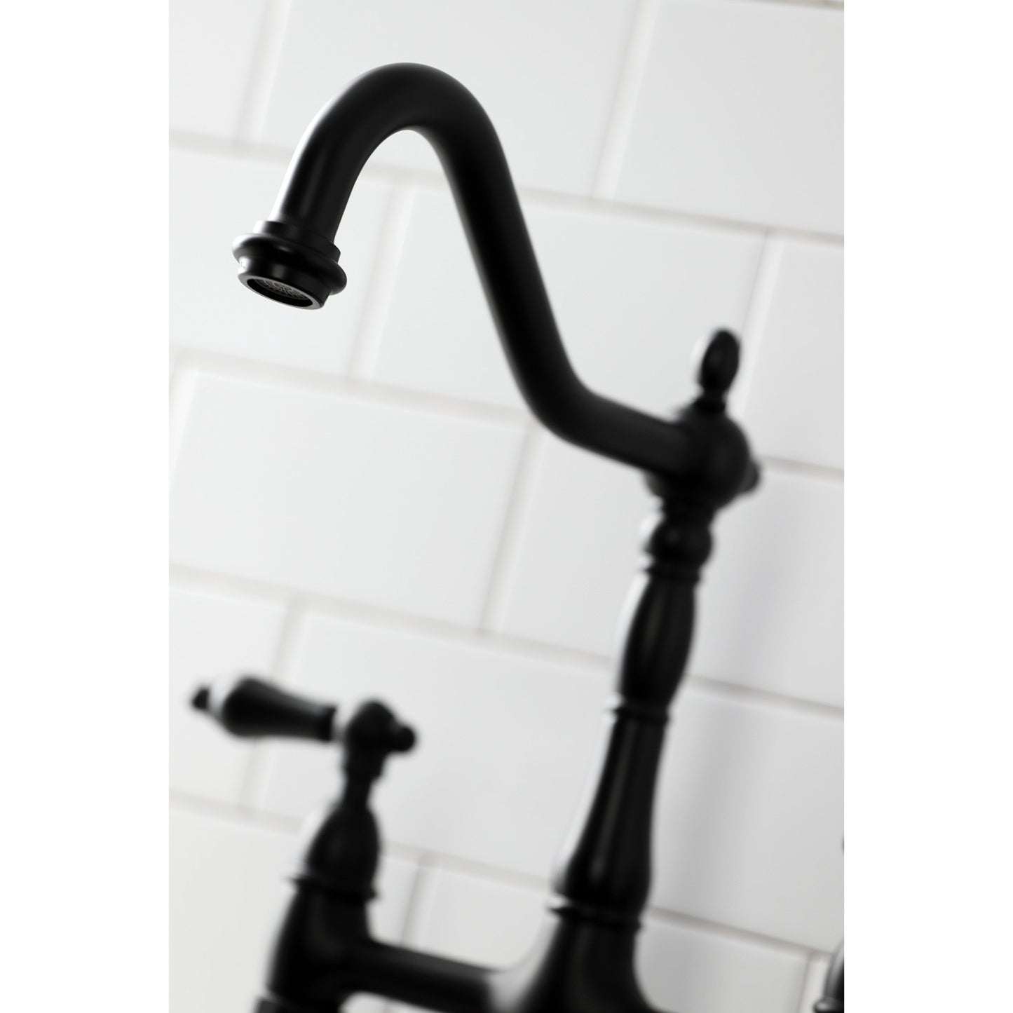 Close up of kitchen faucet head for Kingston Brass KS1270ALBS matte black against white subway tile wall
